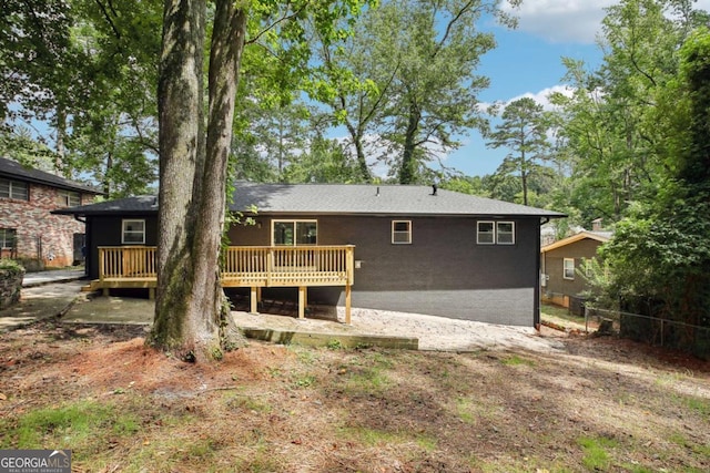 rear view of house with a wooden deck