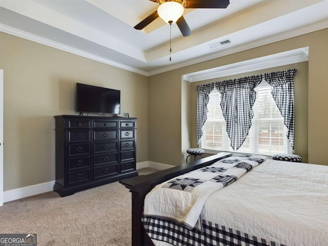 bedroom featuring crown molding, a tray ceiling, ceiling fan, and carpet