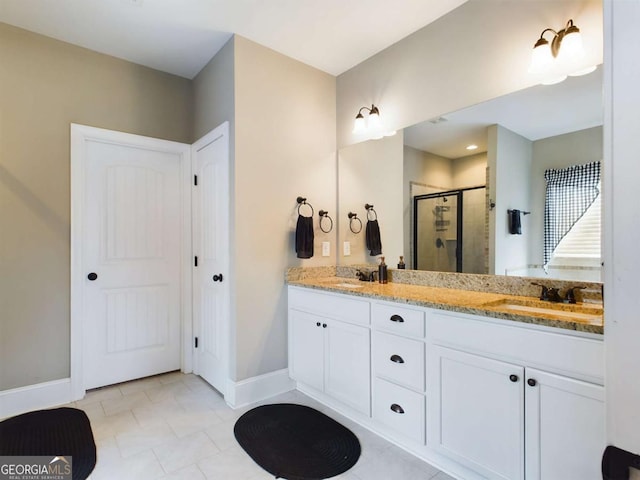 bathroom featuring vanity, tile patterned floors, and a shower with shower door