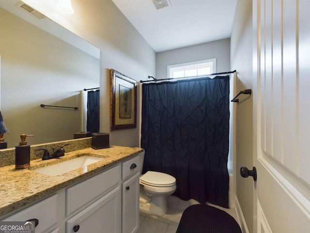 bathroom featuring vanity, tile patterned floors, and toilet