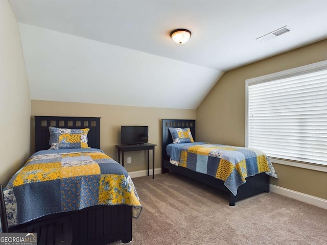 bedroom with lofted ceiling and carpet flooring