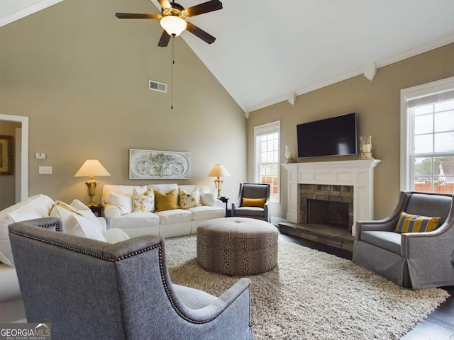 living room with ornamental molding, wood-type flooring, and a healthy amount of sunlight