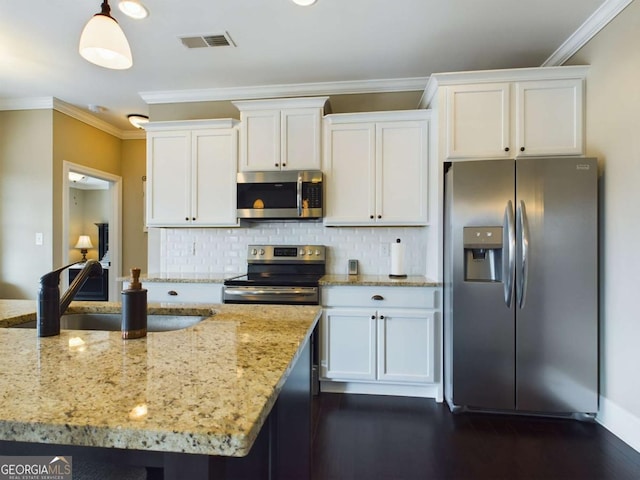 kitchen with sink, white cabinetry, hanging light fixtures, stainless steel appliances, and light stone countertops