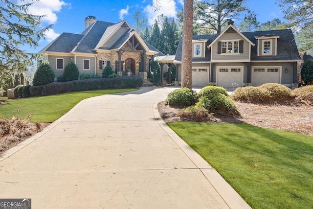 craftsman inspired home with a garage and a front lawn