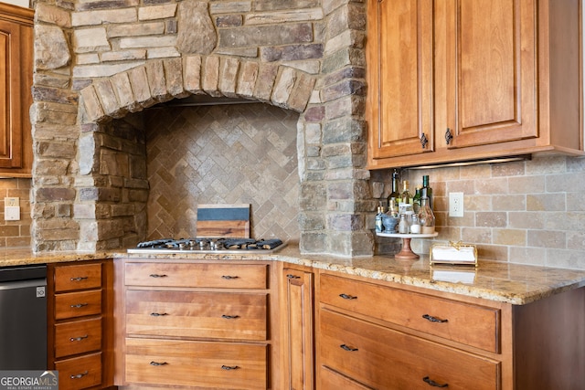 kitchen with light stone countertops, black dishwasher, backsplash, and stainless steel gas cooktop