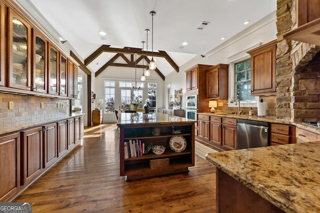 kitchen featuring tasteful backsplash, decorative light fixtures, lofted ceiling with beams, dark hardwood / wood-style flooring, and stainless steel appliances