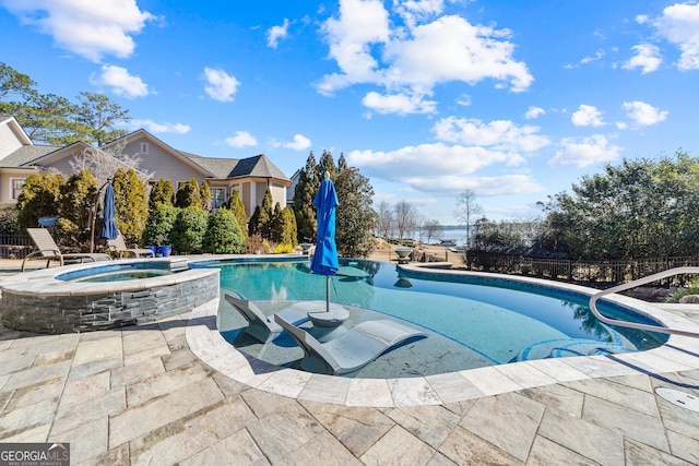 view of swimming pool with an in ground hot tub and a patio area