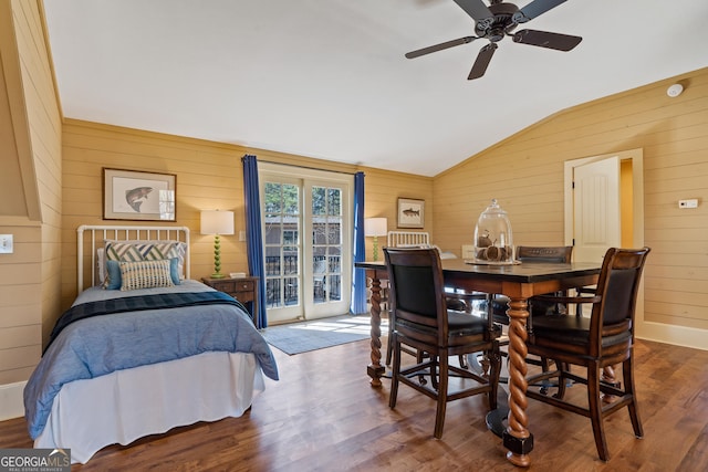 bedroom with wood-type flooring, lofted ceiling, access to outside, and wooden walls