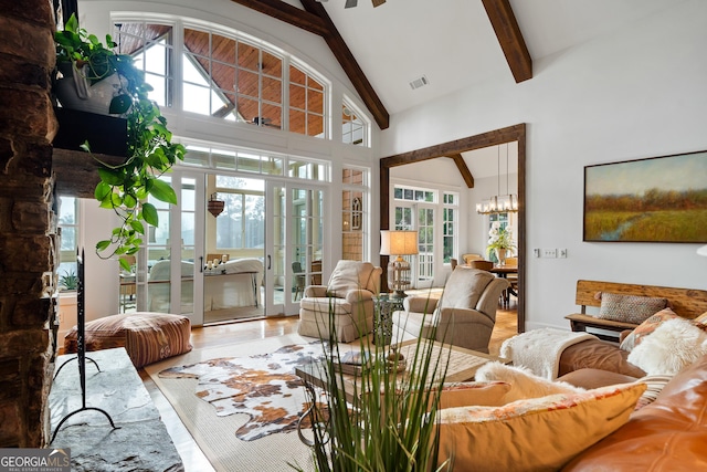 living room with hardwood / wood-style floors, high vaulted ceiling, french doors, and beamed ceiling