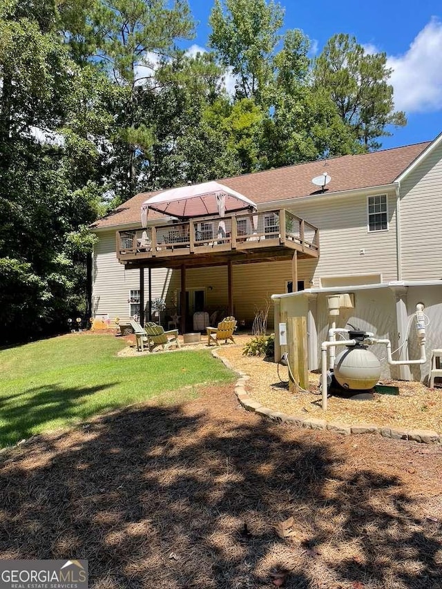 back of house with a deck and a lawn