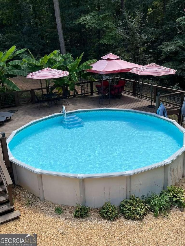 view of swimming pool with a wooden deck