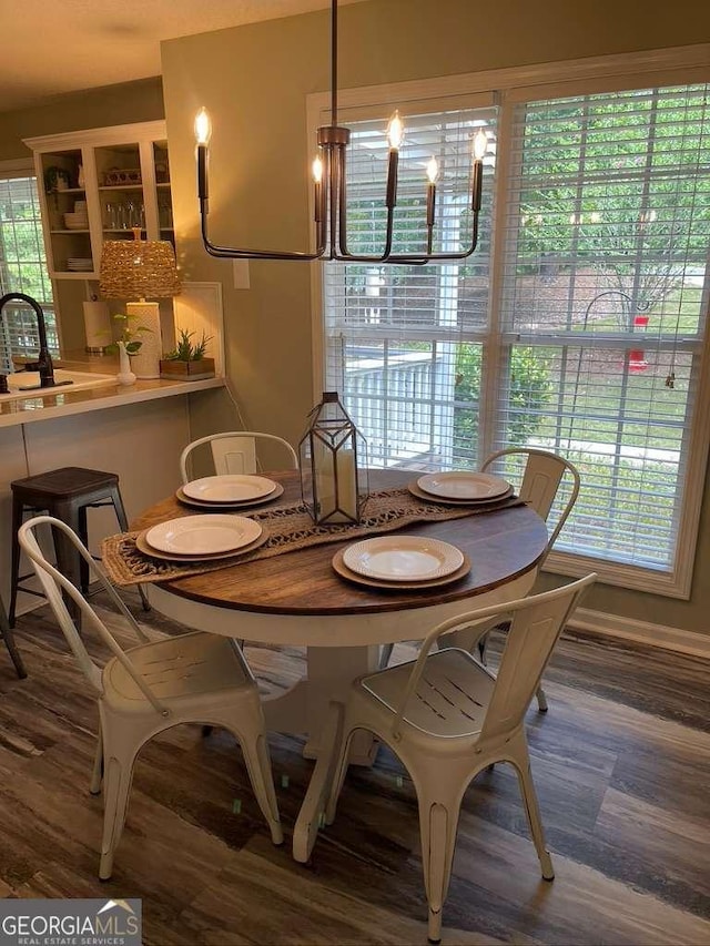 dining room with wood-type flooring and sink