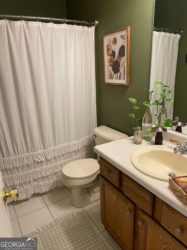 bathroom with tile patterned floors, toilet, and vanity