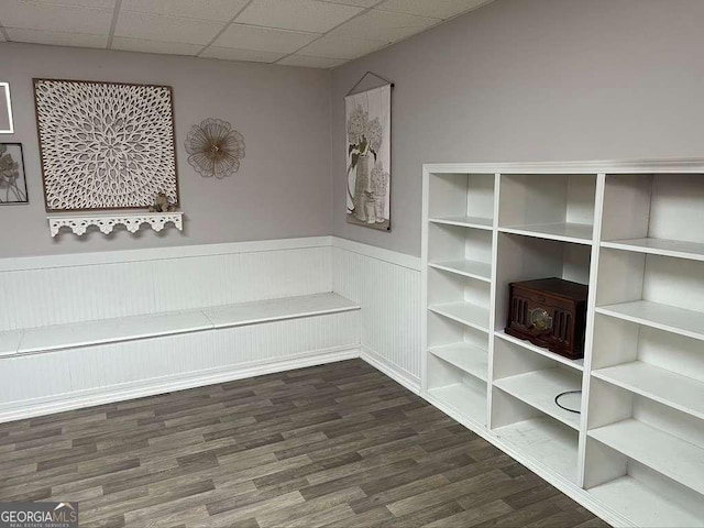 interior space featuring hardwood / wood-style floors and a drop ceiling