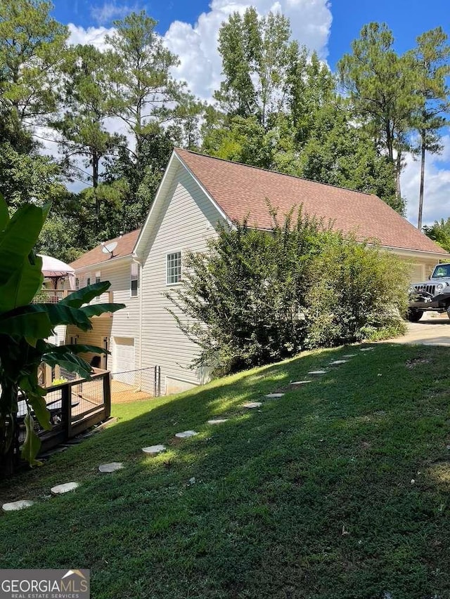 view of side of home featuring a lawn