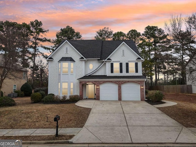 view of front of home with central AC and a garage