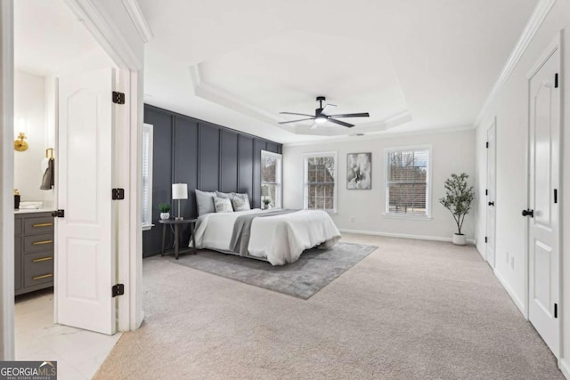 bedroom with light carpet, ornamental molding, a raised ceiling, and ceiling fan