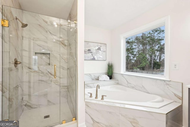 bathroom featuring shower with separate bathtub