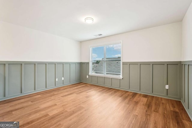 spare room with light wood-type flooring