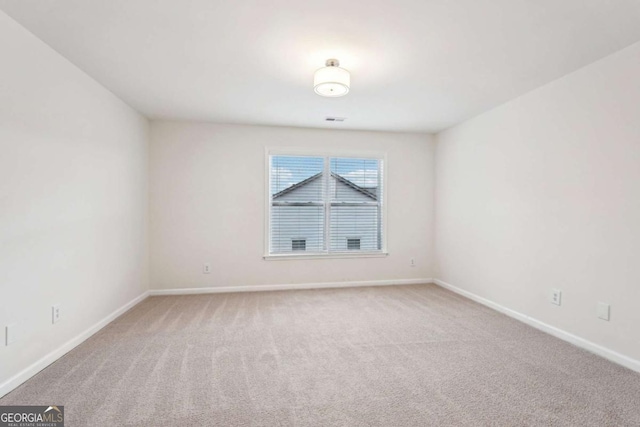 spare room with light colored carpet