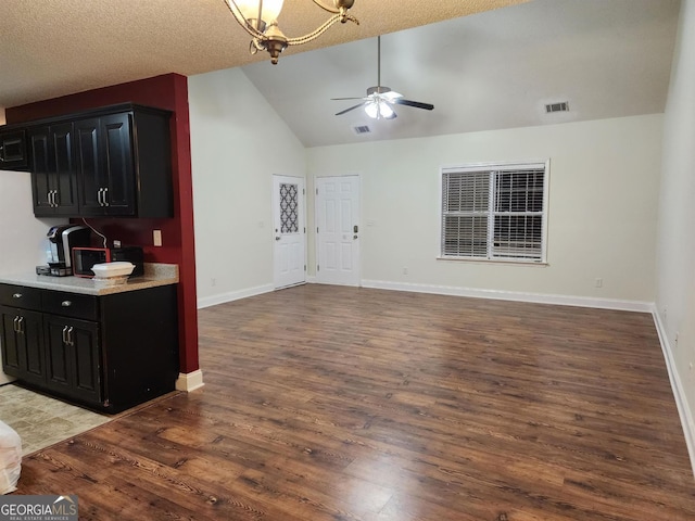 kitchen with ceiling fan, wood-type flooring, and high vaulted ceiling