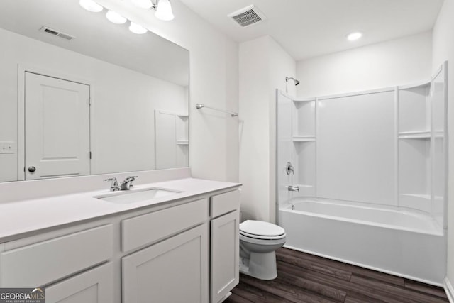 full bathroom featuring bathing tub / shower combination, hardwood / wood-style floors, vanity, and toilet