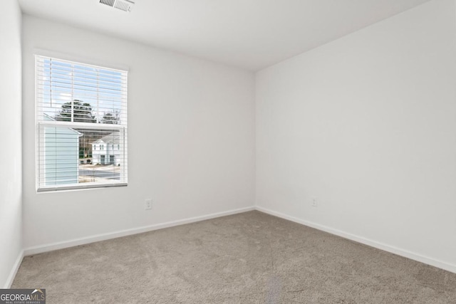 spare room with light carpet