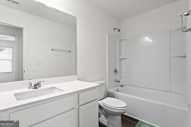 full bathroom featuring vanity, hardwood / wood-style floors, shower / tub combination, and toilet