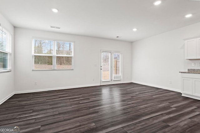 unfurnished living room featuring dark hardwood / wood-style floors