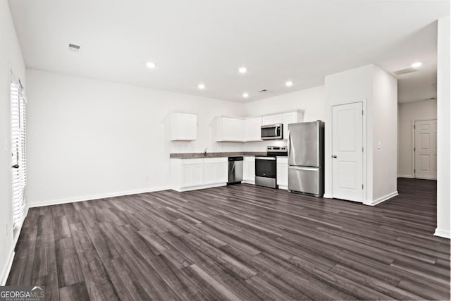 kitchen featuring white cabinetry, stainless steel appliances, and dark wood-type flooring