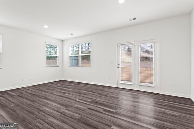 empty room with dark wood-type flooring