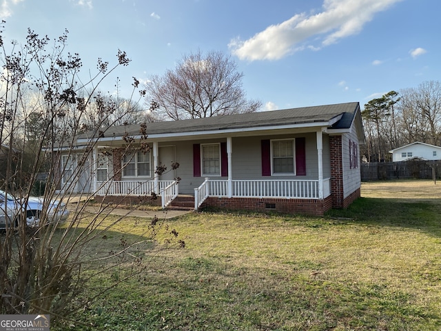 single story home with a front yard and covered porch