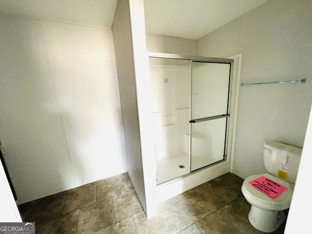 bathroom featuring walk in shower and toilet