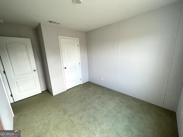 unfurnished bedroom with dark colored carpet