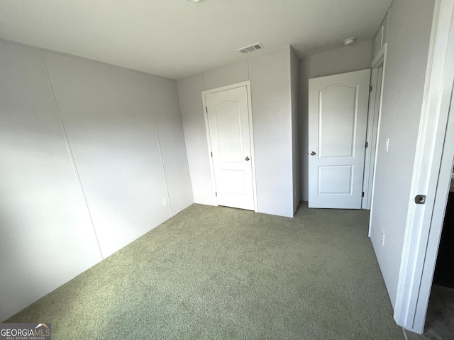 unfurnished bedroom with dark carpet