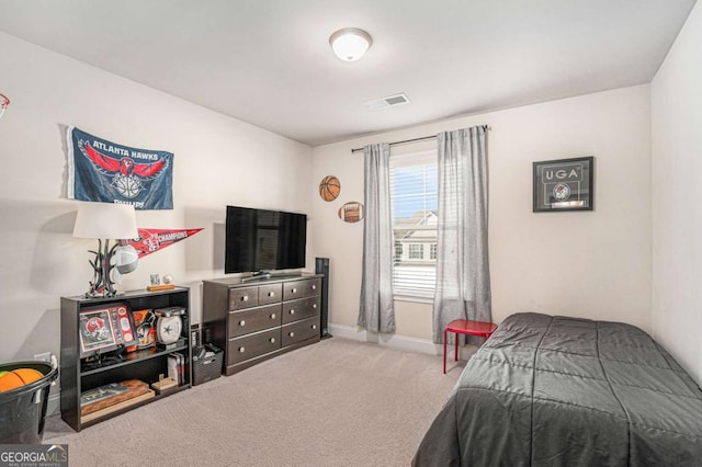 bedroom featuring light carpet