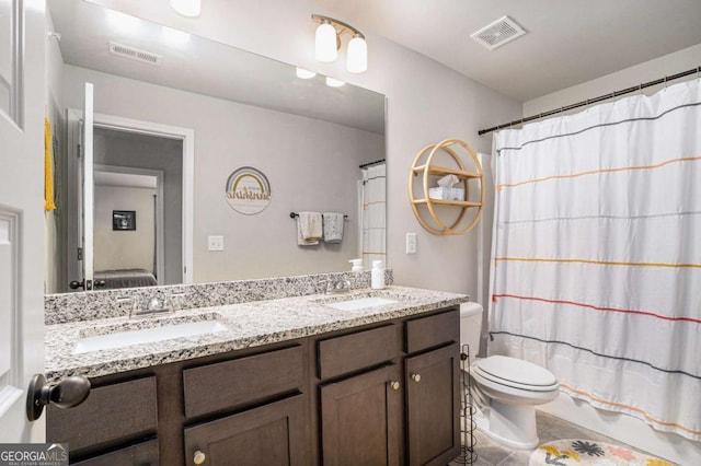 bathroom with vanity, tile patterned floors, and toilet