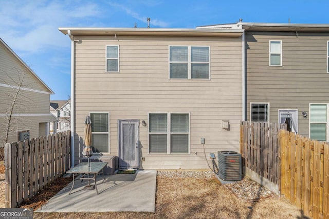 rear view of property featuring central AC and a patio area