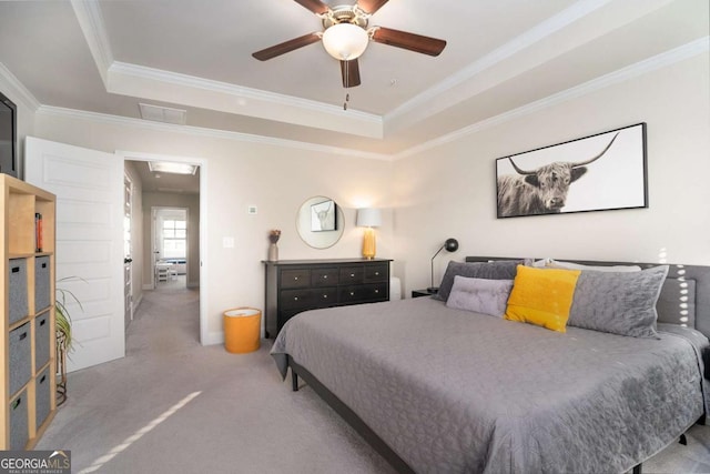 carpeted bedroom featuring crown molding, a raised ceiling, and ceiling fan