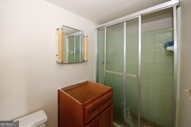 bathroom featuring an enclosed shower and toilet