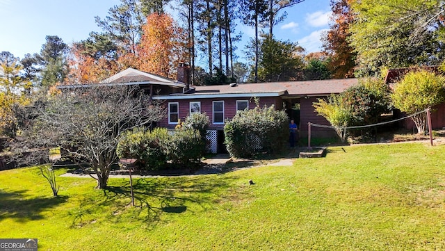 back of property featuring a lawn