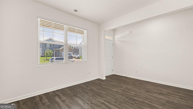 spare room with dark hardwood / wood-style floors