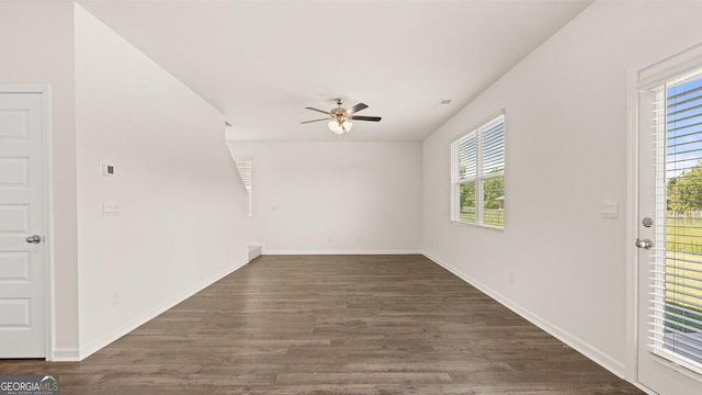 spare room featuring dark wood-type flooring and ceiling fan