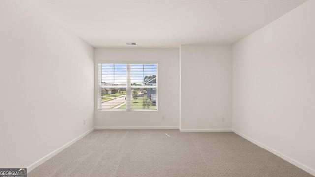 unfurnished room with light colored carpet