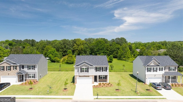 view of front of home featuring a garage and a front lawn