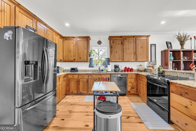 kitchen with sink, light hardwood / wood-style flooring, ornamental molding, stainless steel appliances, and light stone countertops