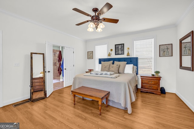 bedroom with crown molding, ceiling fan, and light hardwood / wood-style flooring