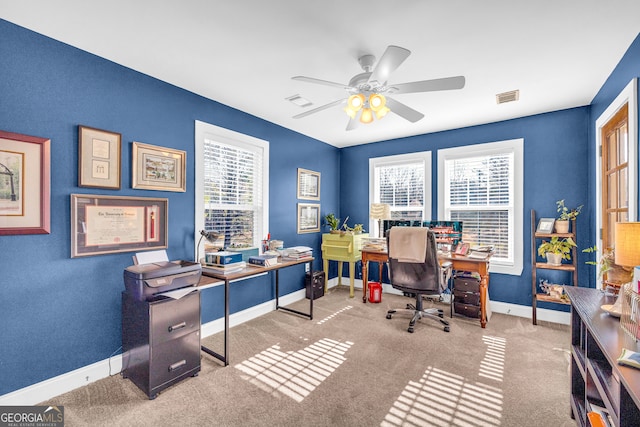 carpeted office space with ceiling fan