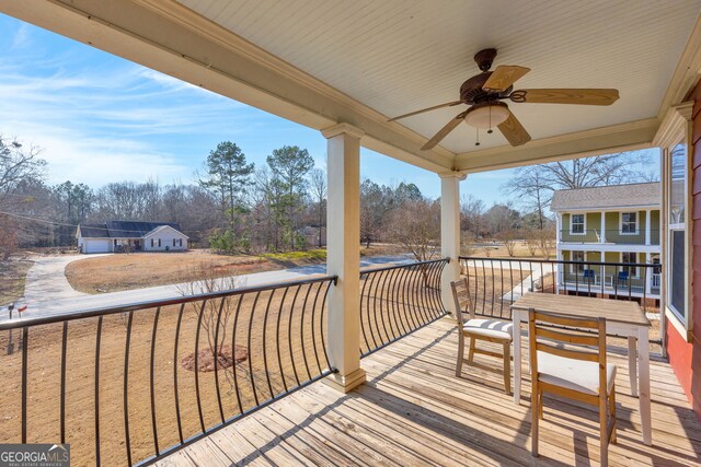 wooden deck featuring ceiling fan