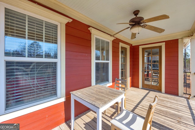 wooden deck featuring ceiling fan